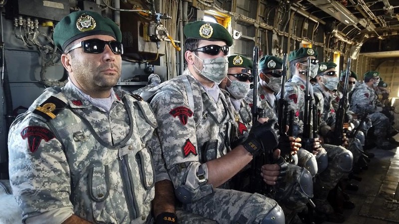 This image made from a video released on Wednesday, Jan. 13, 2021, by the Iranian Army shows troops leaving a helicopter on Makran logistics vessel during a navy drill. Iran's navy began a short-range missile drill in the Gulf of Oman on Wednesday, state TV reported, amid heightened regional tensions over Tehran's nuclear program and a U.S. pressure campaign against the Islamic Republic. (Iranian Army via AP)