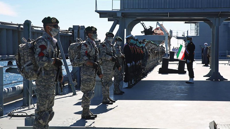 This image made from a video released on Wednesday, Jan. 13, 2021, by the Iranian Army shows troops leaving a helicopter on Makran logistics vessel during a navy drill. Iran's navy began a short-range missile drill in the Gulf of Oman on Wednesday, state TV reported, amid heightened regional tensions over Tehran's nuclear program and a U.S. pressure campaign against the Islamic Republic. (Iranian Army via AP)