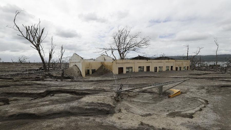 Damaged houses lie at Taal volcano almost a year after it erupted on Sunday, Jan. 10, 2021 in Batangas province, Philippines. A popular tourist destination just south of Manila because of its picturesque setting in the middle of a lake, Taal erupted on Jan. 12, 2020. The eruption displaced thousands of villagers living near the area and delivered an early crisis this year for one of the world's most disaster-prone nations a couple of months before the COVID-19 pandemic broke in the country. (AP Photo/Aaron Favila)
