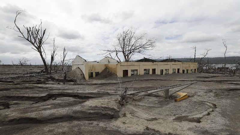 Damaged houses lie at Taal volcano almost a year after it erupted on Sunday, Jan. 10, 2021 in Batangas province, Philippines. A popular tourist destination just south of Manila because of its picturesque setting in the middle of a lake, Taal erupted on Jan. 12, 2020. The eruption displaced thousands of villagers living near the area and delivered an early crisis this year for one of the world's most disaster-prone nations a couple of months before the COVID-19 pandemic broke in the country. (AP Photo/Aaron Favila)