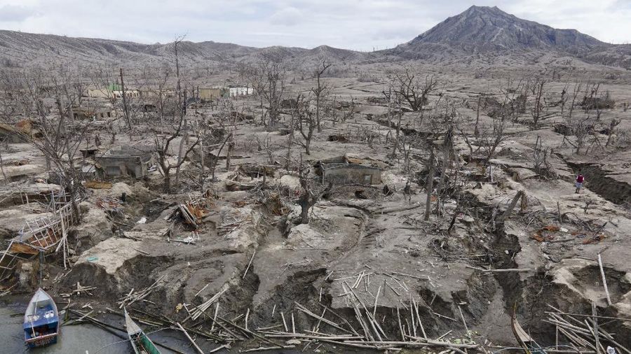 Damaged houses lie at Taal volcano almost a year after it erupted on Sunday, Jan. 10, 2021 in Batangas province, Philippines. A popular tourist destination just south of Manila because of its picturesque setting in the middle of a lake, Taal erupted on Jan. 12, 2020. The eruption displaced thousands of villagers living near the area and delivered an early crisis this year for one of the world's most disaster-prone nations a couple of months before the COVID-19 pandemic broke in the country. (AP Photo/Aaron Favila)