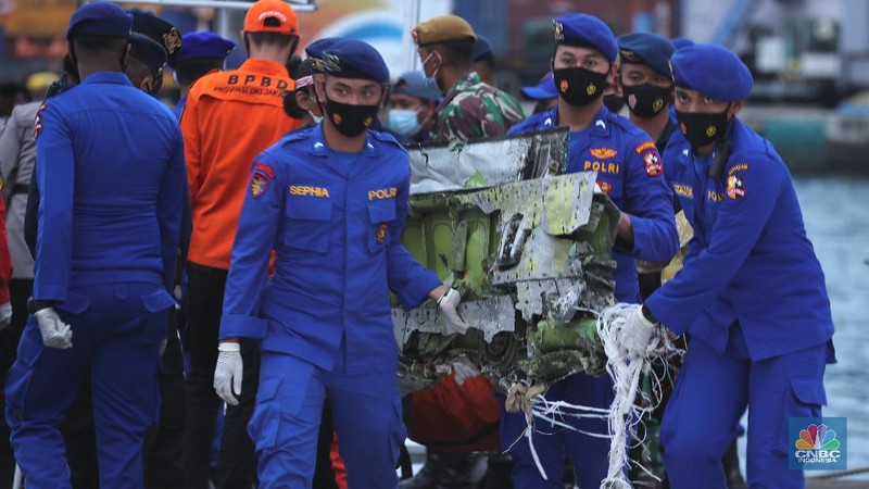 Petugas Basarnas menurunkan kantong jenazah dan puing korban pesawat Sriwijaya Air SJ182 yang jatuh di perairan Kepulauan Seribu, Kamis (14/1/2021). Selanjutnya tim Basarnas menyerahkan beberapa kantong jenazah yang telah dikumpulkan kepada Tim DVI dan KNKT untuk pemeriksaan (CNBC Indonesia/ Tri Susilo)
