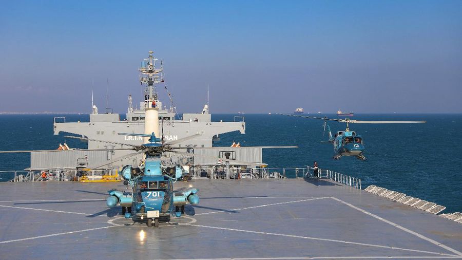 This image released Thursday, Jan. 14, 2021, by the Iranian Army shows helicopters and the Iranian-made Makran logistics vessel during a naval drill. Iran fired cruise missiles Thursday as part of the drill in the Gulf of Oman, state media reported, amid heightened tensions with the U.S. (Iranian Army via AP)
