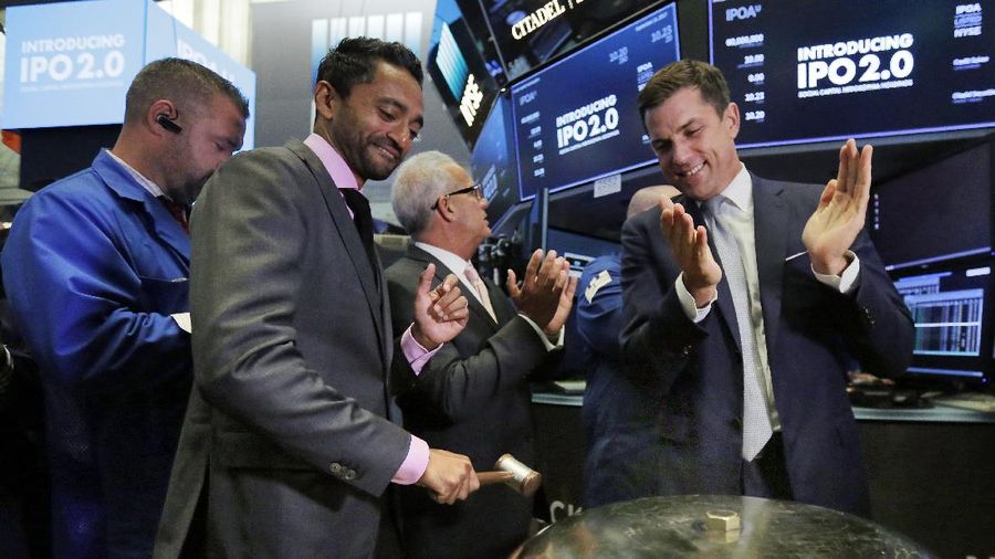 Social Capital Hedosophia Holdings Corp. CEO, Founder and Chairman Chamath Palihapitiya, left, is applauded by New York Stock Exchange president Tom Farley as he rings a ceremonial bell when his company's stock begins trading on the floor of the New York Stock Exchange, Thursday, Sept. 14, 2017. (AP Photo/Richard Drew)