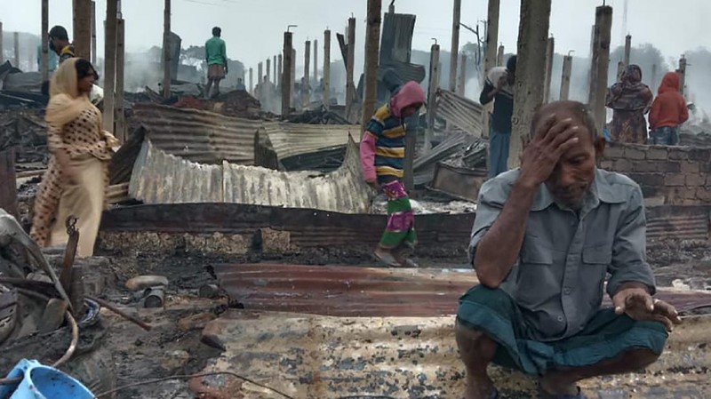 This frame grab from video shows flames rising after a fire broke out in Nayapara Camp in Cox's Bazar district, Bangladesh, Thursday, Jan. 14, 2021. A fire raced through a sprawling Rohingya refugee camp in southern Bangladesh on Thursday, destroying hundreds of homes, officials said. No casualties were reported. The UNHCR said more than 550 homes sheltering about 3,500 people as well as 150 shops were either totally or partially destroyed in the fire.  (AP Photo)