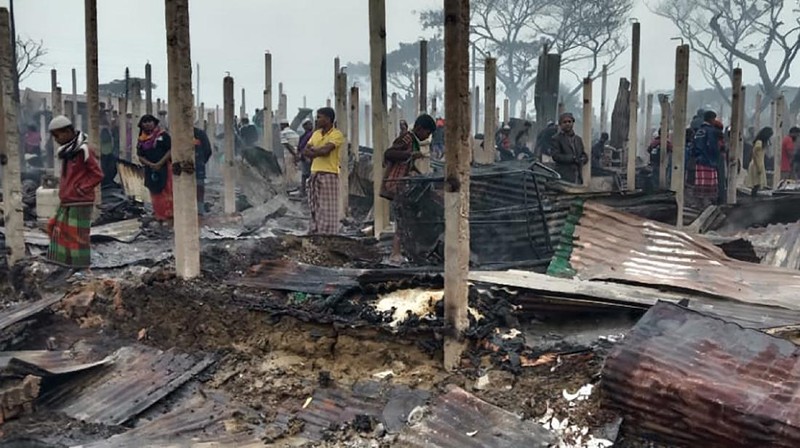 This frame grab from video shows flames rising after a fire broke out in Nayapara Camp in Cox's Bazar district, Bangladesh, Thursday, Jan. 14, 2021. A fire raced through a sprawling Rohingya refugee camp in southern Bangladesh on Thursday, destroying hundreds of homes, officials said. No casualties were reported. The UNHCR said more than 550 homes sheltering about 3,500 people as well as 150 shops were either totally or partially destroyed in the fire.  (AP Photo)