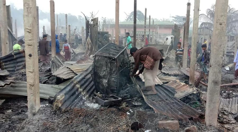 This frame grab from video shows flames rising after a fire broke out in Nayapara Camp in Cox's Bazar district, Bangladesh, Thursday, Jan. 14, 2021. A fire raced through a sprawling Rohingya refugee camp in southern Bangladesh on Thursday, destroying hundreds of homes, officials said. No casualties were reported. The UNHCR said more than 550 homes sheltering about 3,500 people as well as 150 shops were either totally or partially destroyed in the fire.  (AP Photo)