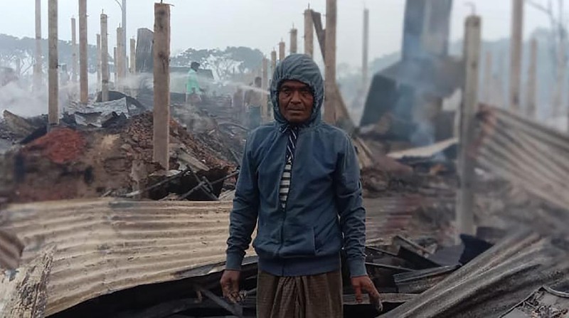This frame grab from video shows flames rising after a fire broke out in Nayapara Camp in Cox's Bazar district, Bangladesh, Thursday, Jan. 14, 2021. A fire raced through a sprawling Rohingya refugee camp in southern Bangladesh on Thursday, destroying hundreds of homes, officials said. No casualties were reported. The UNHCR said more than 550 homes sheltering about 3,500 people as well as 150 shops were either totally or partially destroyed in the fire.  (AP Photo)