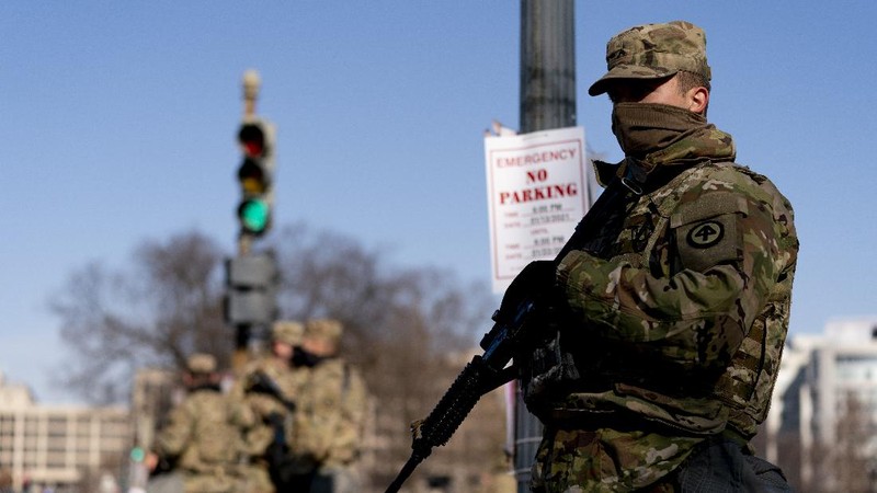 Military trucks are stationed behind perimeter fencing near Union Station on Capitol Hill in Washington, Thursday, Jan. 14, 2021. (AP Photo/Andrew Harnik)