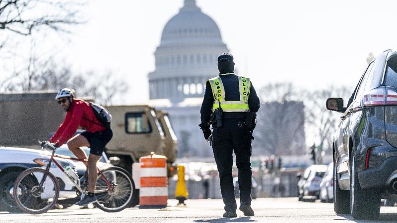 Military trucks are stationed behind perimeter fencing near Union Station on Capitol Hill in Washington, Thursday, Jan. 14, 2021. (AP Photo/Andrew Harnik)