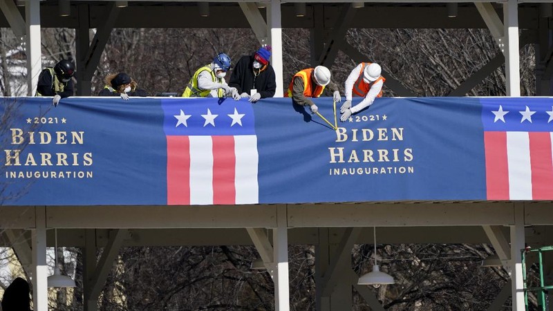 Military trucks are stationed behind perimeter fencing near Union Station on Capitol Hill in Washington, Thursday, Jan. 14, 2021. (AP Photo/Andrew Harnik)