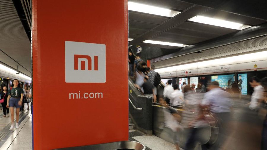 FILE - In this July 9, 2018, file photo, an advertisement for Xiaomi is displayed at a subway station in Hong Kong. The U.S. government has blacklisted Chinese smartphone maker Xiaomi Corp. and China’s third-largest national oil company for alleged military links, heaping pressure on Beijing in President Donald Trump’s last week in office. The Department of Defense added nine companies to its list of Chinese companies with military links, including Xiaomi and state-owned plane manufacturer Commercial Aircraft Corp. of China (Comac). (AP Photo/Vincent Yu, File)
