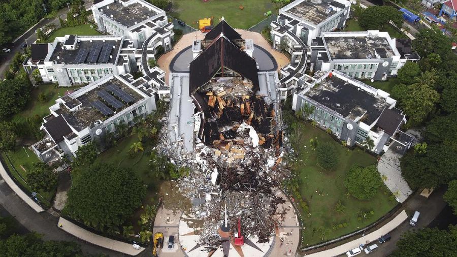 A government building is seen badly damaged following an earthquake in this aerial photo taken using a drone in Mamuju, West Sulawesi, Indonesia, Saturday, Jan. 16, 2021. Damaged roads and bridges, power blackouts and lack of heavy equipment on Saturday hampered Indonesia's rescuers after a strong and shallow earthquake left a number of people dead and injured on Sulawesi island. (AP Photo/Abdi Latief)