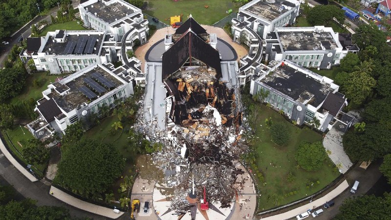 A government building is seen badly damaged following an earthquake in this aerial photo taken using a drone in Mamuju, West Sulawesi, Indonesia, Saturday, Jan. 16, 2021. Damaged roads and bridges, power blackouts and lack of heavy equipment on Saturday hampered Indonesia's rescuers after a strong and shallow earthquake left a number of people dead and injured on Sulawesi island. (AP Photo/Abdi Latief)