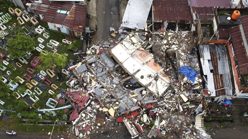 A government building is seen badly damaged following an earthquake in this aerial photo taken using a drone in Mamuju, West Sulawesi, Indonesia, Saturday, Jan. 16, 2021. Damaged roads and bridges, power blackouts and lack of heavy equipment on Saturday hampered Indonesia's rescuers after a strong and shallow earthquake left a number of people dead and injured on Sulawesi island. (AP Photo/Abdi Latief)