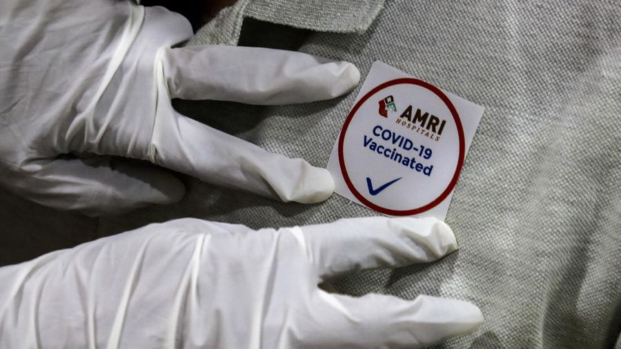 A health worker, left, prepares to administer COVID-19 vaccine to a doctor at a government Hospital in Hyderabad, India, Saturday, Jan. 16, 2021. India started inoculating health workers Saturday in what is likely the world's largest COVID-19 vaccination campaign, joining the ranks of wealthier nations where the effort is already well underway. (AP Photo/Mahesh Kumar A.)