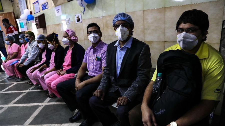 First batch of health workers wait for their turn to get vaccinated at a hospital in Kolkata, India, Saturday, Jan. 16, 2021. India started inoculating health workers Saturday in what is likely the world's largest COVID-19 vaccination campaign, joining the ranks of wealthier nations where the effort is already well underway. (AP Photo/Bikas Das)