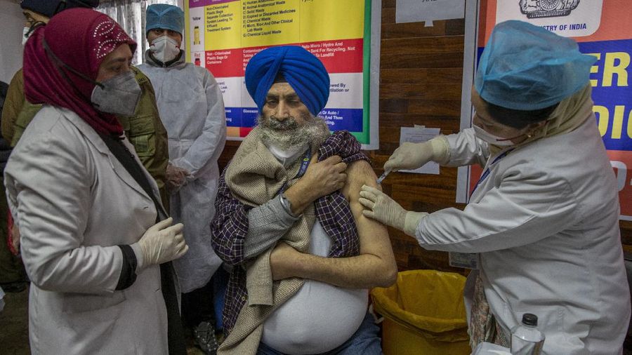 A hospital staff receives a COVID-19 vaccine at a government Hospital in Srinagar, Indian controlled Kashmir, Saturday, Jan. 16, 2021. India started inoculating health workers Saturday in what is likely the world's largest COVID-19 vaccination campaign, joining the ranks of wealthier nations where the effort is already well underway. (AP Photo/ Dar Yasin)