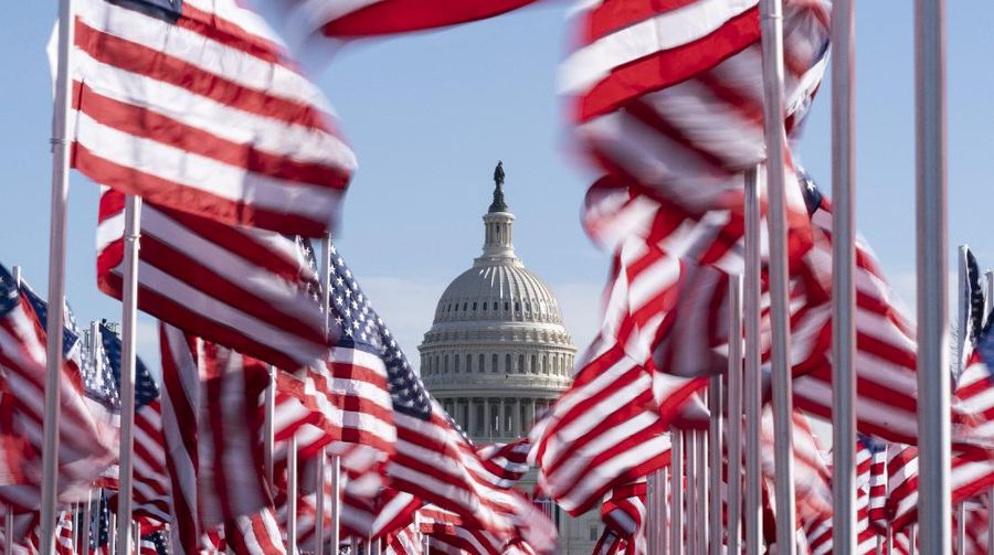 The U.S. Capitol is seen between flags placed on the National Mall ahead of the inauguration of President-elect Joe Biden and Vice President-elect Kamala Harris, Monday, Jan. 18, 2021, in Washington.