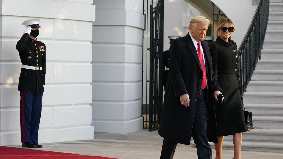 President Donald Trump and first lady Melania Trump walk to board Marine One on the South Lawn of the White House, Wednesday, Jan. 20, 2021, in Washington. Trump is en route to his Mar-a-Lago Florida Resort. (AP Photo/Alex Brandon)