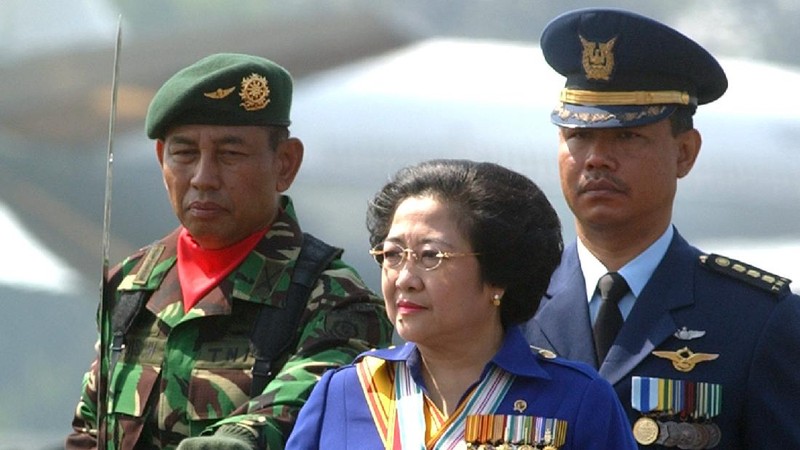 FILE--Megawati Sukarnoputri, left, is embraced by her father and Indonesia's first president Sukarno at the State Palace in Jakarta on Jan. 10, 1960. Megawati, now 54, has assumed her late father's mantle and is set to move back into the palace where she grew up. The legislature removed President Abdurrahman Wahid on Monday, July 23, 2001. Megawati, who had been vice president, was sworn in as president. (AP Photo)