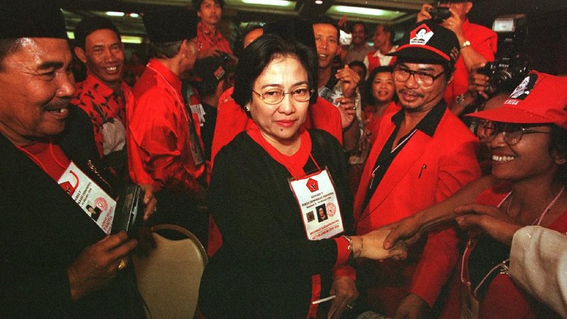 FILE--Megawati Sukarnoputri, left, is embraced by her father and Indonesia's first president Sukarno at the State Palace in Jakarta on Jan. 10, 1960. Megawati, now 54, has assumed her late father's mantle and is set to move back into the palace where she grew up. The legislature removed President Abdurrahman Wahid on Monday, July 23, 2001. Megawati, who had been vice president, was sworn in as president. (AP Photo)