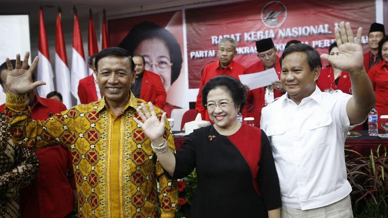 FILE--Megawati Sukarnoputri, left, is embraced by her father and Indonesia's first president Sukarno at the State Palace in Jakarta on Jan. 10, 1960. Megawati, now 54, has assumed her late father's mantle and is set to move back into the palace where she grew up. The legislature removed President Abdurrahman Wahid on Monday, July 23, 2001. Megawati, who had been vice president, was sworn in as president. (AP Photo)