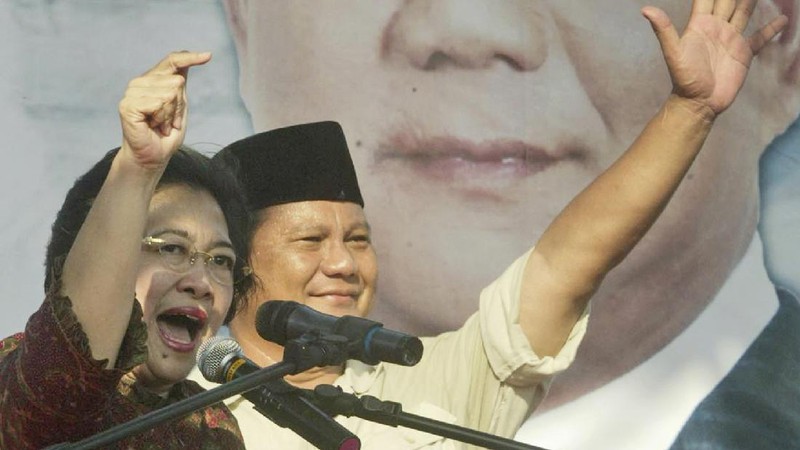 FILE--Megawati Sukarnoputri, left, is embraced by her father and Indonesia's first president Sukarno at the State Palace in Jakarta on Jan. 10, 1960. Megawati, now 54, has assumed her late father's mantle and is set to move back into the palace where she grew up. The legislature removed President Abdurrahman Wahid on Monday, July 23, 2001. Megawati, who had been vice president, was sworn in as president. (AP Photo)