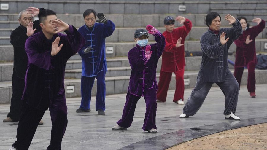 Residents practice Taiji at a park in Wuhan in central China's Hubei Province on Saturday, Jan. 23, 2021. A year after it was locked down to contain the spread of coronavirus, the central Chinese city of Wuhan has largely returned to normal, even as China continues to battle outbreaks elsewhere in the country. (AP Photo/Ng Han Guan)