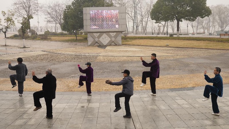 Residents practice Taiji at a park in Wuhan in central China's Hubei Province on Saturday, Jan. 23, 2021. A year after it was locked down to contain the spread of coronavirus, the central Chinese city of Wuhan has largely returned to normal, even as China continues to battle outbreaks elsewhere in the country. (AP Photo/Ng Han Guan)