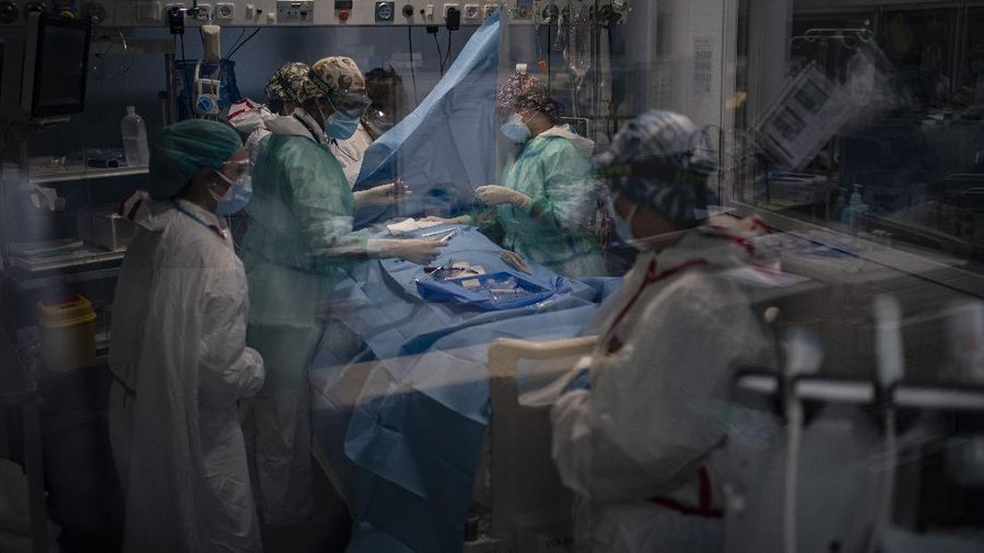 A COVID-19 patient receives treatment in the ICU of the Hospital del Mar, in Barcelona, Spain, Tuesday, Jan. 19, 2021. The unrelenting increase in COVID-19 infections in Spain following the holiday season is again straining hospitals, threatening the mental health of doctors and nurses who have been at the forefront of the pandemic for nearly a year. (AP Photo/Felipe Dana)