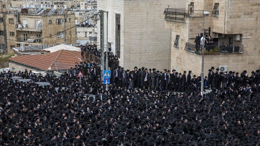 Thousands of ultra-Orthodox Jews participate in tfuneral for prominent rabbi Meshulam Soloveitchik, in Jerusalem, Sunday, Jan. 31, 2021. The mass ceremony took place despite the country's health regulations banning large public gatherings, during a nationwide lockdown to curb the spread of the virus. (AP Photo/Ariel Schalit)
