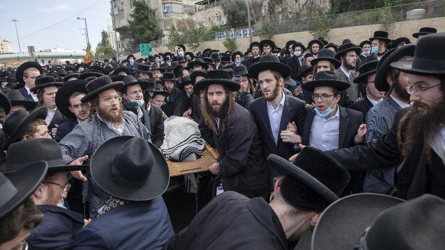 Thousands of ultra-Orthodox Jews participate in tfuneral for prominent rabbi Meshulam Soloveitchik, in Jerusalem, Sunday, Jan. 31, 2021. The mass ceremony took place despite the country's health regulations banning large public gatherings, during a nationwide lockdown to curb the spread of the virus. (AP Photo/Ariel Schalit)