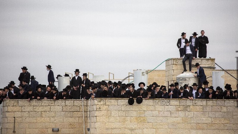 Thousands of ultra-Orthodox Jews participate in tfuneral for prominent rabbi Meshulam Soloveitchik, in Jerusalem, Sunday, Jan. 31, 2021. The mass ceremony took place despite the country's health regulations banning large public gatherings, during a nationwide lockdown to curb the spread of the virus. (AP Photo/Ariel Schalit)