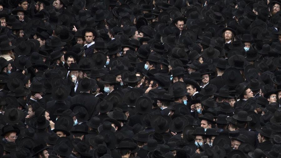 Thousands of ultra-Orthodox Jews participate in tfuneral for prominent rabbi Meshulam Soloveitchik, in Jerusalem, Sunday, Jan. 31, 2021. The mass ceremony took place despite the country's health regulations banning large public gatherings, during a nationwide lockdown to curb the spread of the virus. (AP Photo/Ariel Schalit)