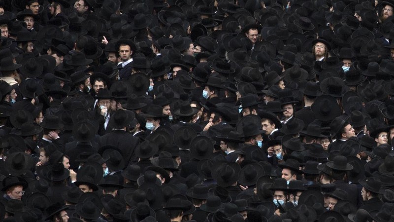 Thousands of ultra-Orthodox Jews participate in tfuneral for prominent rabbi Meshulam Soloveitchik, in Jerusalem, Sunday, Jan. 31, 2021. The mass ceremony took place despite the country's health regulations banning large public gatherings, during a nationwide lockdown to curb the spread of the virus. (AP Photo/Ariel Schalit)