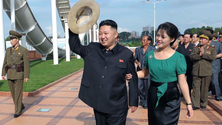In this Wednesday, July 25, 2012 photo released by the Korean Central News Agency (KCNA) and distributed in Tokyo by the Korea News Service Thursday, July 26, 2012, North Korean leader Kim Jong Un, center, accompanied by his wife Ri Sol Ju, right, waves to the crowd as they inspect the Rungna People's Pleasure Ground in Pyongyang. (AP Photo/Korean Central News Agency via Korea News Service) JAPAN OUT UNTIL 14 DAYS AFTER THE DAY OF TRANSMISSION