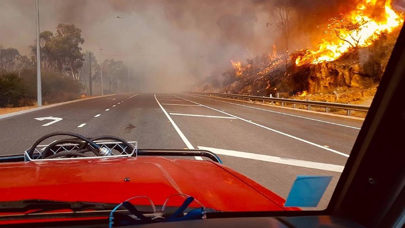 Firefighters attend a fire at Wooroloo, near Perth, Australia, Monday, Feb. 1, 2021. An out-of-control wildfire burning northeast of the Australian west coast city of Perth has destroyed an estimated 30 homes and was threatening more Tuesday, with many locals across the region told it is too late to leave. (Evan Collis/DFES via AP)