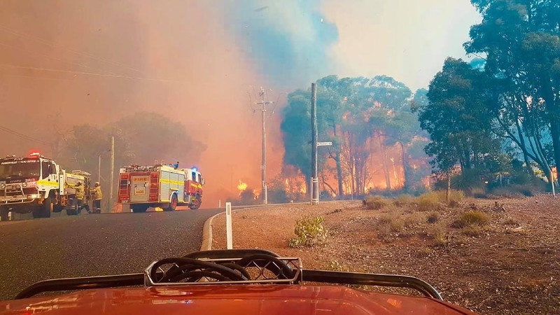 Firefighters attend a fire at Wooroloo, near Perth, Australia, Monday, Feb. 1, 2021. An out-of-control wildfire burning northeast of the Australian west coast city of Perth has destroyed an estimated 30 homes and was threatening more Tuesday, with many locals across the region told it is too late to leave. (Evan Collis/DFES via AP)