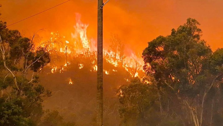 In this photo provided by Department of Fire and Emergency Services, fire burns on a hill at Wooroloo, near Perth, Australia, Monday, Feb. 1, 2021. An out-of-control wildfire burning northeast of the Australian west coast city of Perth has destroyed