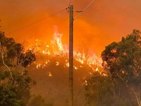In this photo provided by Department of Fire and Emergency Services, fire burns on a hill at Wooroloo, near Perth, Australia, Monday, Feb. 1, 2021. An out-of-control wildfire burning northeast of the Australian west coast city of Perth has destroyed