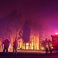 Firefighters attend a fire at Wooroloo, near Perth, Australia, Monday, Feb. 1, 2021. An out-of-control wildfire burning northeast of the Australian west coast city of Perth has destroyed an estimated 30 homes and was threatening more Tuesday, with ma