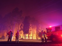 Firefighters attend a fire at Wooroloo, near Perth, Australia, Monday, Feb. 1, 2021. An out-of-control wildfire burning northeast of the Australian west coast city of Perth has destroyed an estimated 30 homes and was threatening more Tuesday, with ma