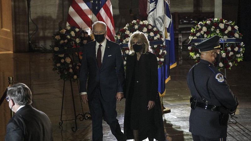 President Joe Biden and first lady Jill Biden leave after paying their respects to U.S. Capitol Police officer Brian Sicknick as an urn with his cremated remains lies in honor on a black-draped table in the Capitol Rotunda, Tuesday, Feb. 2, 2021, in Washington. (Brendan Smialowski/Pool via AP)