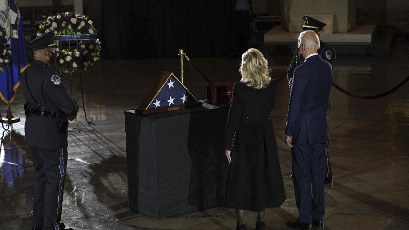 President Joe Biden and first lady Jill Biden leave after paying their respects to U.S. Capitol Police officer Brian Sicknick as an urn with his cremated remains lies in honor on a black-draped table in the Capitol Rotunda, Tuesday, Feb. 2, 2021, in Washington. (Brendan Smialowski/Pool via AP)