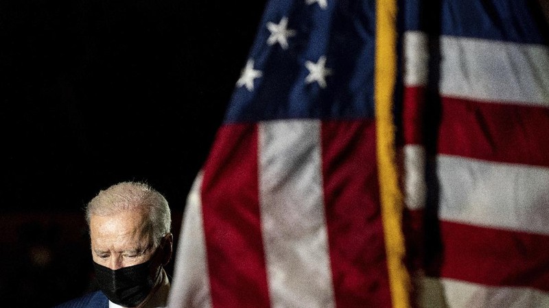 President Joe Biden and first lady Jill Biden leave after paying their respects to U.S. Capitol Police officer Brian Sicknick as an urn with his cremated remains lies in honor on a black-draped table in the Capitol Rotunda, Tuesday, Feb. 2, 2021, in Washington. (Brendan Smialowski/Pool via AP)