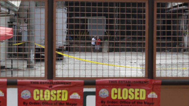 Rescuers stand inside the compound of the TP Marcelo Ice Plant Thursday, Feb. 4, 2021 in Navotas, Philippines. An ammonia leak from the ice plant in the Philippine capital region left some dead and more than 90 other injured or sickened while hundreds of residents fled to safety, an official said. The plant was ordered closed shortly after the leak. (AP Photo/Aaron Favila)