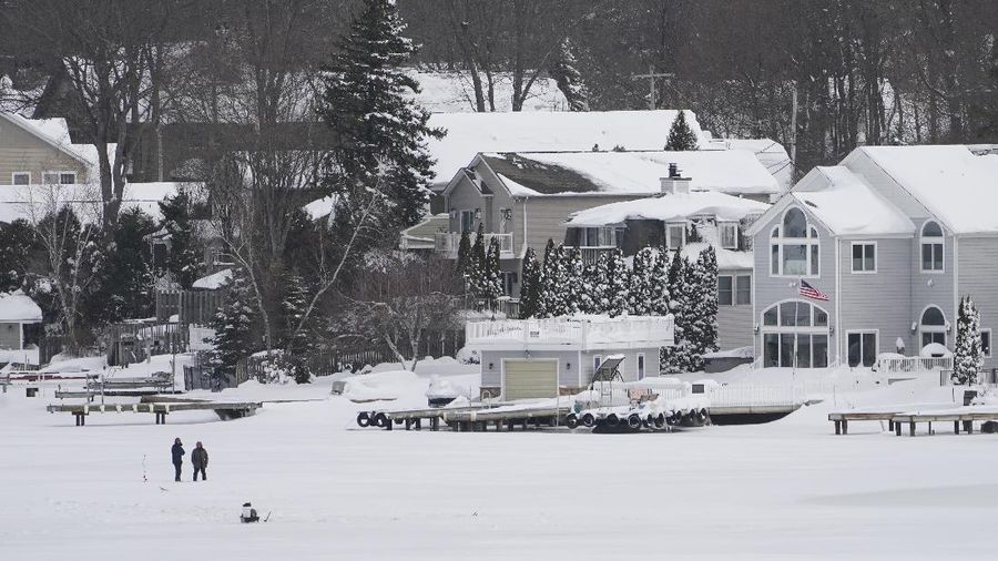Houses along the shore of a snowed-over Lake Hopatcong are seen in Mt. Arlington, N.J., Wednesday, Feb. 3, 2021. This week's winter storm appears to have broken a 122-year-old record for the most snow in a New Jersey community from one storm. The National Weather Service made a preliminary report Tuesday that Mount Arlington in the northern part of the state got 35.5 inches of snow in the three-day storm. (AP Photo/Seth Wenig)