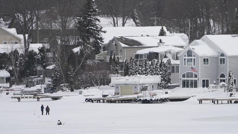 Houses along the shore of a snowed-over Lake Hopatcong are seen in Mt. Arlington, N.J., Wednesday, Feb. 3, 2021. This week's winter storm appears to have broken a 122-year-old record for the most snow in a New Jersey community from one storm. The National Weather Service made a preliminary report Tuesday that Mount Arlington in the northern part of the state got 35.5 inches of snow in the three-day storm. (AP Photo/Seth Wenig)