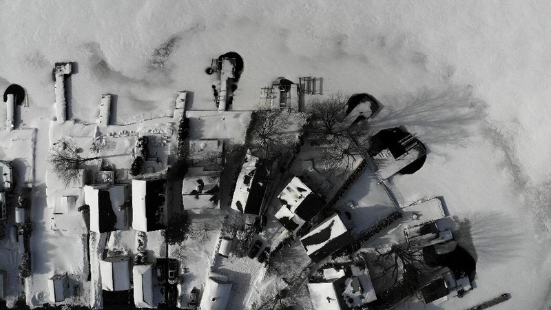 Houses along the shore of a snowed-over Lake Hopatcong are seen in Mt. Arlington, N.J., Wednesday, Feb. 3, 2021. This week's winter storm appears to have broken a 122-year-old record for the most snow in a New Jersey community from one storm. The National Weather Service made a preliminary report Tuesday that Mount Arlington in the northern part of the state got 35.5 inches of snow in the three-day storm. (AP Photo/Seth Wenig)